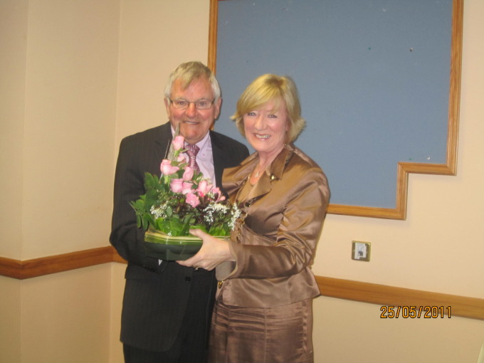 Dorothy receiving a presentation from Sean Oman on behalf of the members