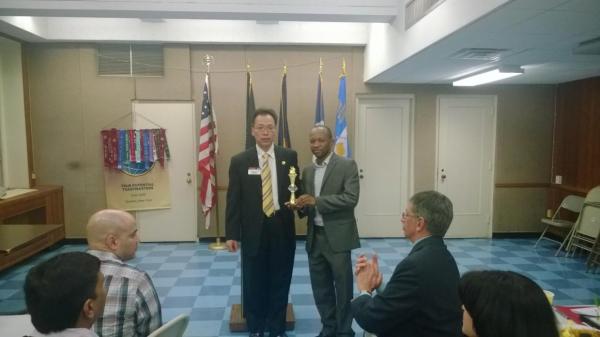 Above: Kazuo Noguchi, District Governor, presents trophy to Club President for Club's 30th Anniversary